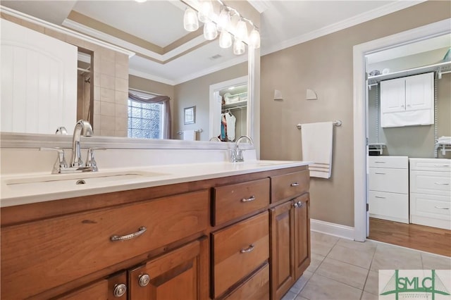 bathroom featuring crown molding, double vanity, a sink, and tile patterned floors