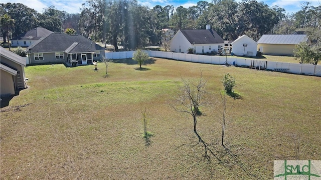 view of yard with a sunroom and a fenced backyard