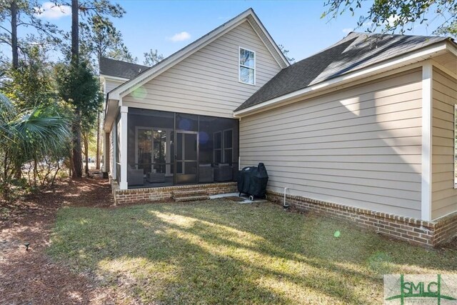 230 Blackjack Oak Dr W, Richmond Hill, GA 31324 - back of house featuring a sunroom, a yard, and roof with shingles