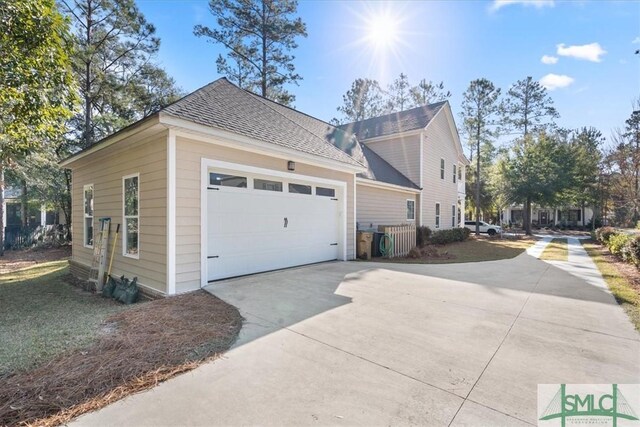 230 Blackjack Oak Dr W, Richmond Hill, GA 31324 - view of home's exterior featuring a garage, driveway, and roof with shingles