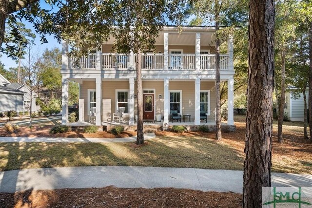 230 Blackjack Oak Dr W, Richmond Hill, GA 31324 - townhome / multi-family property with a balcony, covered porch, and a front lawn