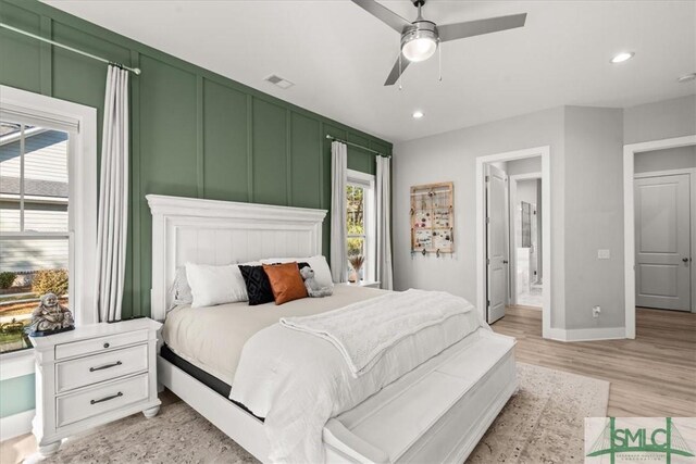 230 Blackjack Oak Dr W, Richmond Hill, GA 31324 - bedroom with light wood-style floors, recessed lighting, a ceiling fan, and a decorative wall