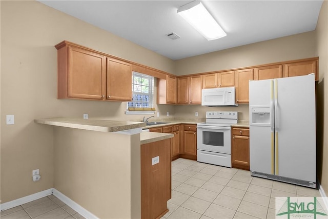 kitchen with white appliances, light tile patterned floors, a peninsula, light countertops, and a sink