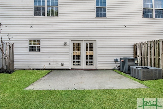 back of property featuring a patio area, a lawn, fence, and cooling unit