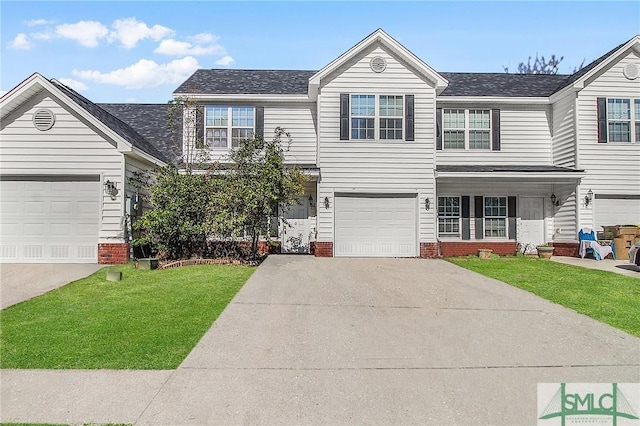 traditional-style home featuring a garage, concrete driveway, and a front lawn