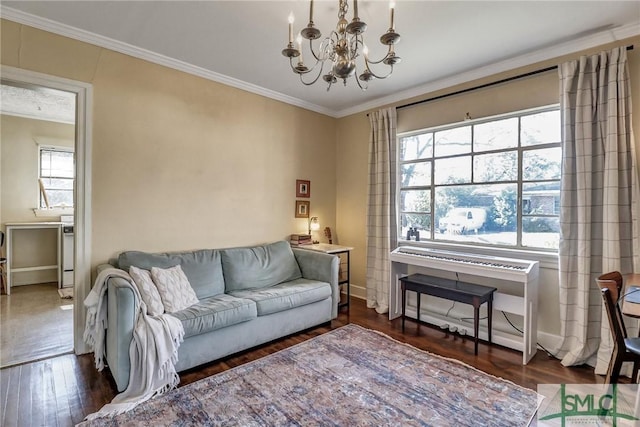 living room featuring an inviting chandelier, plenty of natural light, and ornamental molding