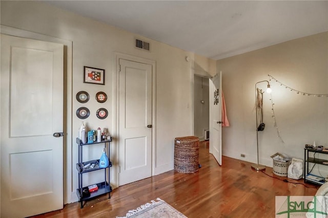 interior space with visible vents and wood finished floors