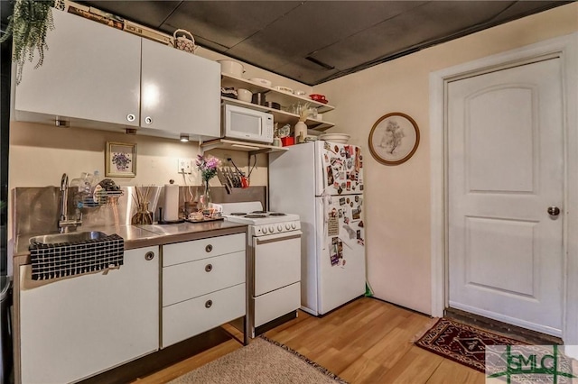 kitchen featuring white appliances, white cabinets, stainless steel counters, open shelves, and light wood finished floors