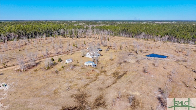 drone / aerial view featuring a view of trees