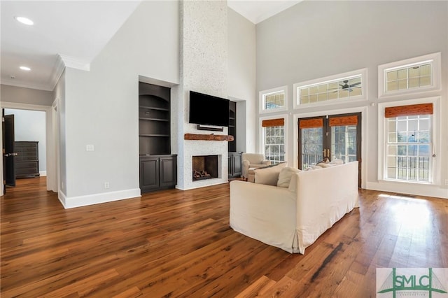 106 Commodore Dr, Savannah, GA 31410 - unfurnished living room featuring baseboards, built in features, ornamental molding, french doors, and dark wood-style flooring