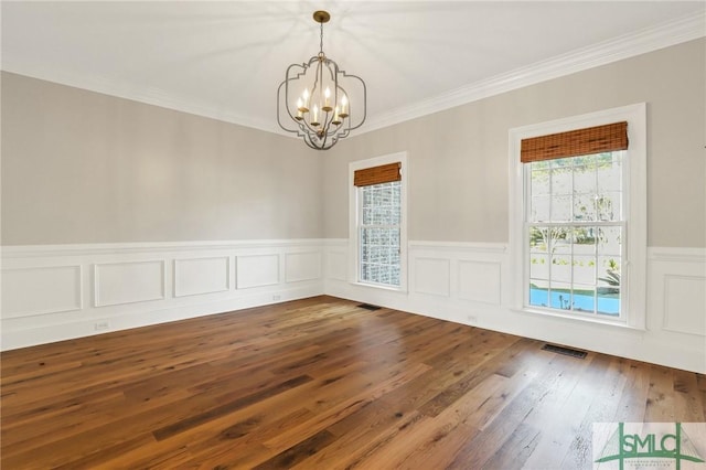 106 Commodore Dr, Savannah, GA 31410 - unfurnished dining area with a notable chandelier, visible vents, dark wood finished floors, and crown molding