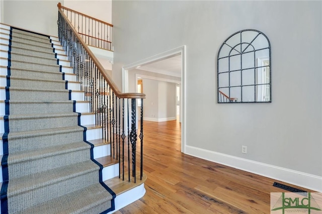 106 Commodore Dr, Savannah, GA 31410 - stairway with wood finished floors, baseboards, and a towering ceiling