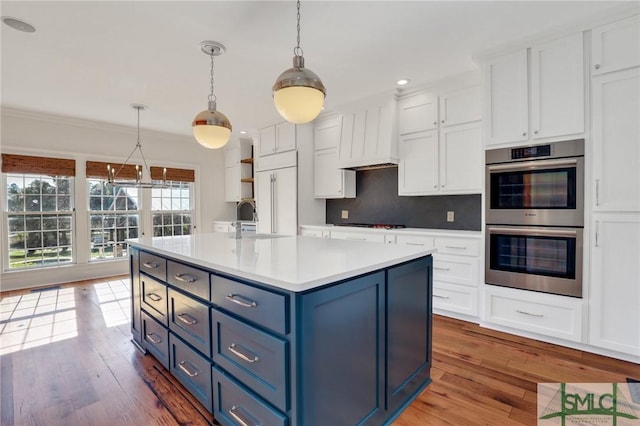 106 Commodore Dr, Savannah, GA 31410 - kitchen featuring blue cabinetry, double oven, and white cabinetry