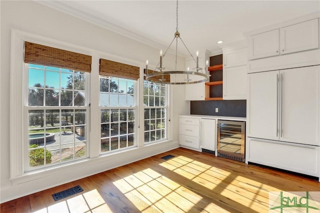 106 Commodore Dr, Savannah, GA 31410 - kitchen featuring beverage cooler, visible vents, open shelves, paneled built in fridge, and a notable chandelier