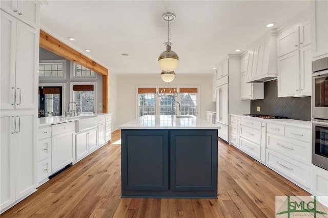 106 Commodore Dr, Savannah, GA 31410 - kitchen with light wood-style floors, backsplash, light countertops, and white cabinetry