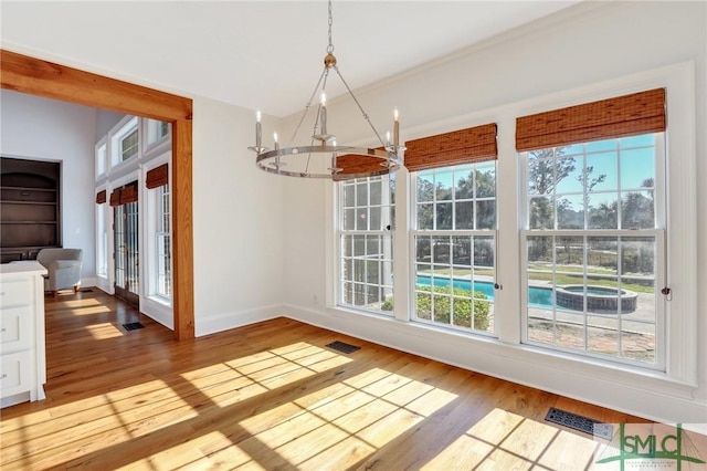 106 Commodore Dr, Savannah, GA 31410 - unfurnished dining area with baseboards, wood finished floors, visible vents, and a chandelier