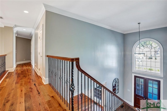 106 Commodore Dr, Savannah, GA 31410 - hallway with an upstairs landing, ornamental molding, wood finished floors, french doors, and baseboards