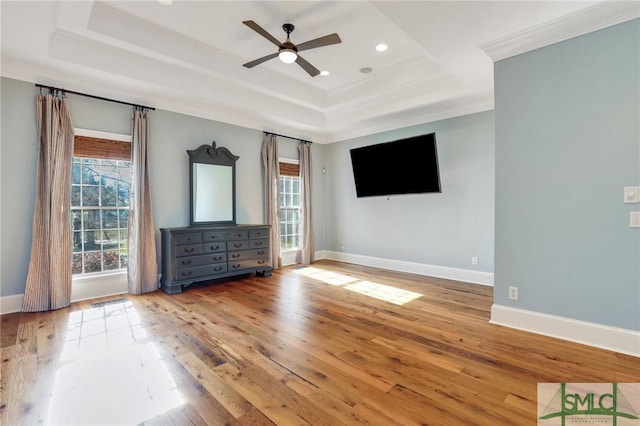 106 Commodore Dr, Savannah, GA 31410 - unfurnished living room featuring a tray ceiling, wood-type flooring, and a wealth of natural light