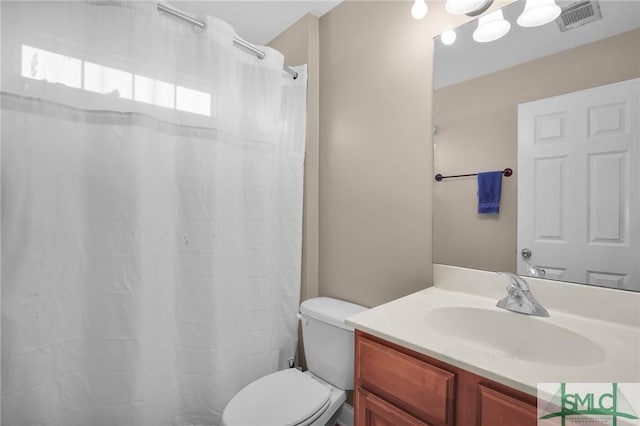 full bath featuring visible vents, vanity, and toilet