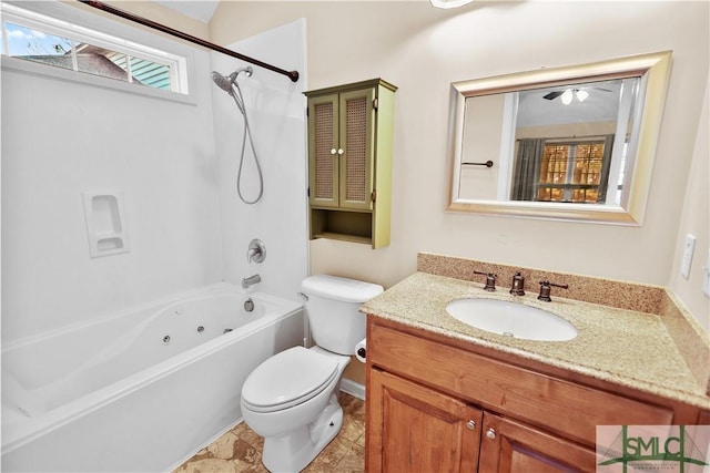 bathroom with washtub / shower combination, toilet, a wealth of natural light, and vanity