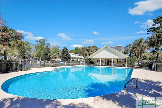 pool featuring fence and a patio