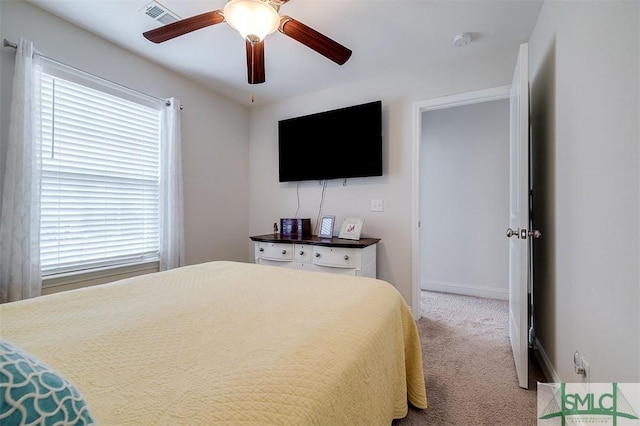 carpeted bedroom with ceiling fan, visible vents, and baseboards