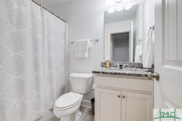 bathroom with vanity, toilet, and tile patterned floors