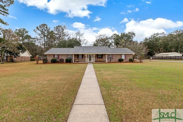 single story home with a front yard and brick siding