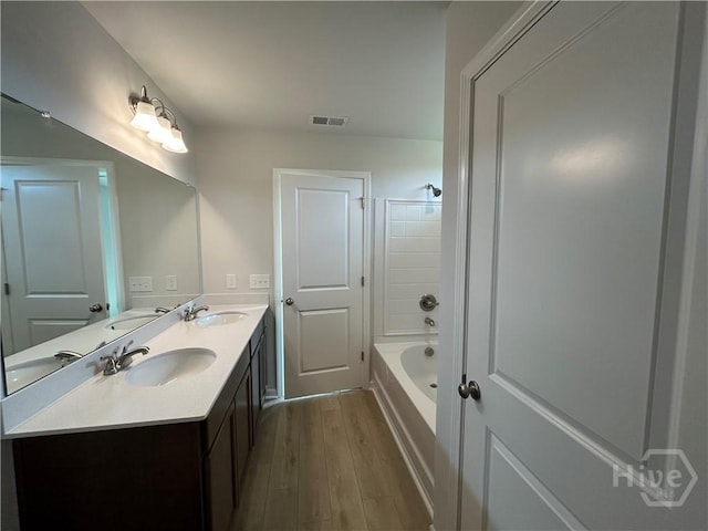 108 Stillhouse Dr, Springfield, GA 31329 - full bathroom featuring double vanity, wood finished floors, and shower / bath combination