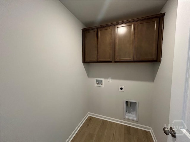 108 Stillhouse Dr, Springfield, GA 31329 - laundry room featuring electric dryer hookup, washer hookup, wood finished floors, and cabinet space