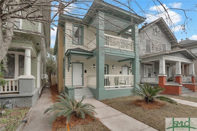 italianate-style house featuring a porch and a balcony
