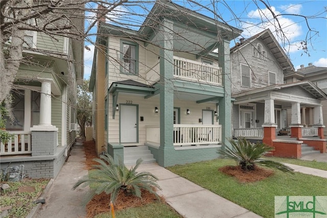 italianate home featuring a porch and a balcony