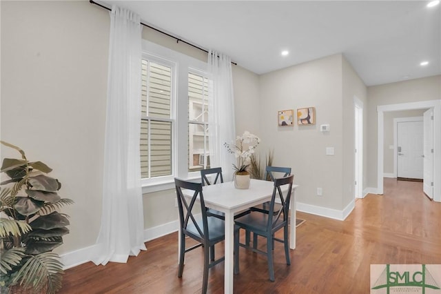 dining space featuring wood finished floors, baseboards, and recessed lighting