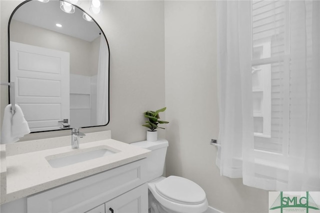 half bathroom with toilet and vanity