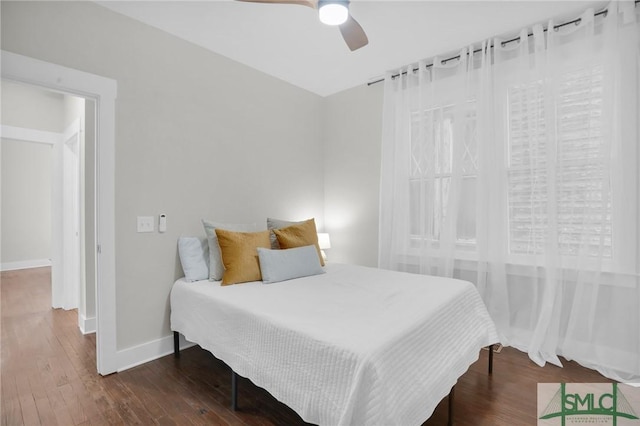 bedroom with baseboards, wood-type flooring, and a ceiling fan