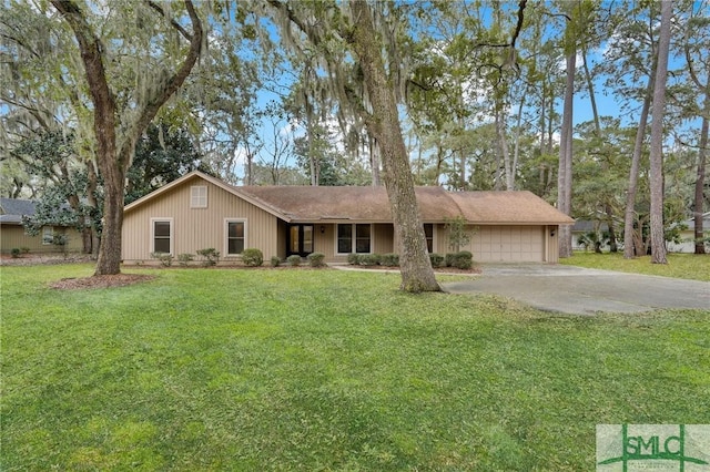 ranch-style house featuring a garage, driveway, and a front yard