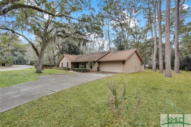 ranch-style house featuring driveway, a garage, and a front lawn