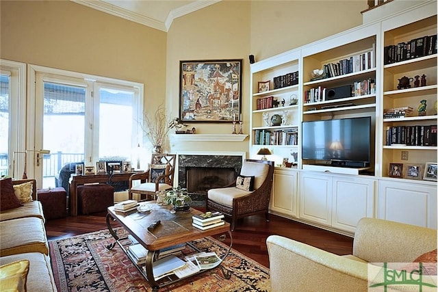 sitting room featuring ornamental molding, dark wood-style flooring, and a fireplace