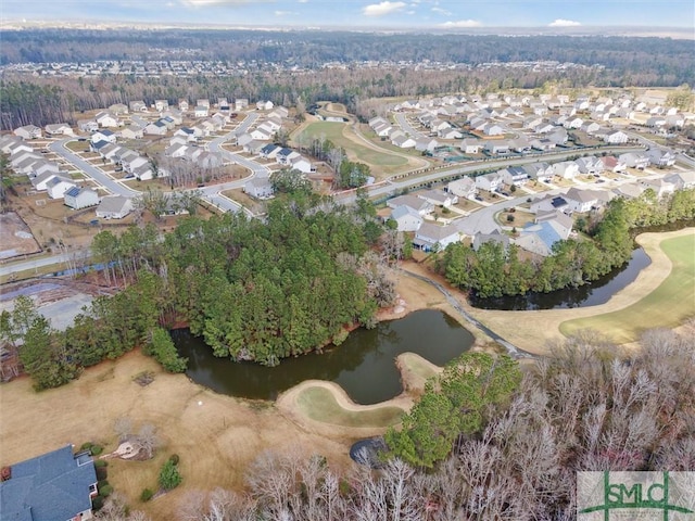 drone / aerial view featuring a water view, view of golf course, and a residential view