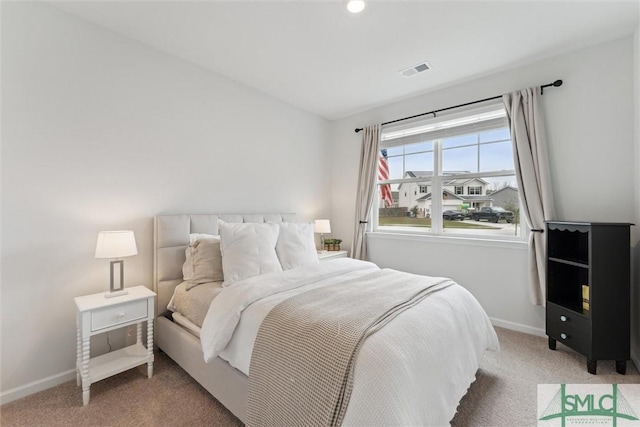 bedroom with baseboards, visible vents, and carpet flooring