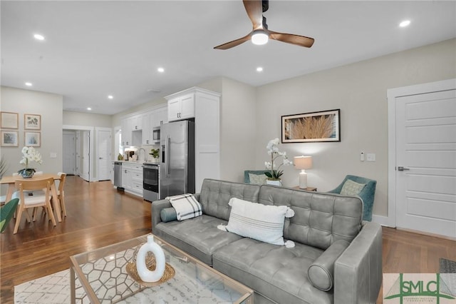 living area featuring dark wood-style floors, a ceiling fan, and recessed lighting