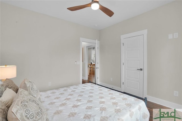 bedroom featuring ceiling fan, baseboards, and wood finished floors