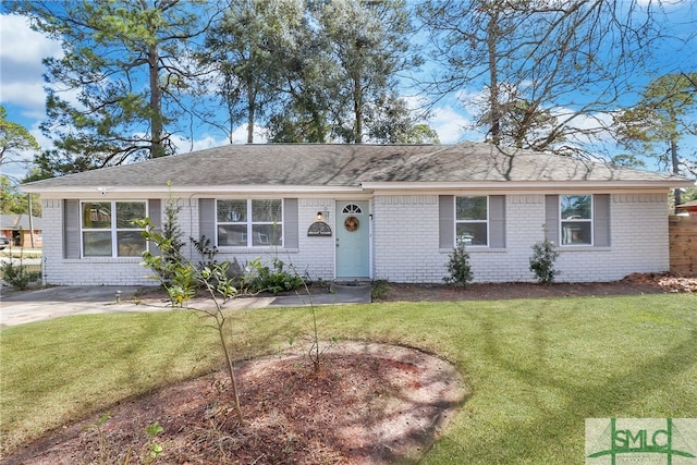 single story home with brick siding, a front yard, and a shingled roof