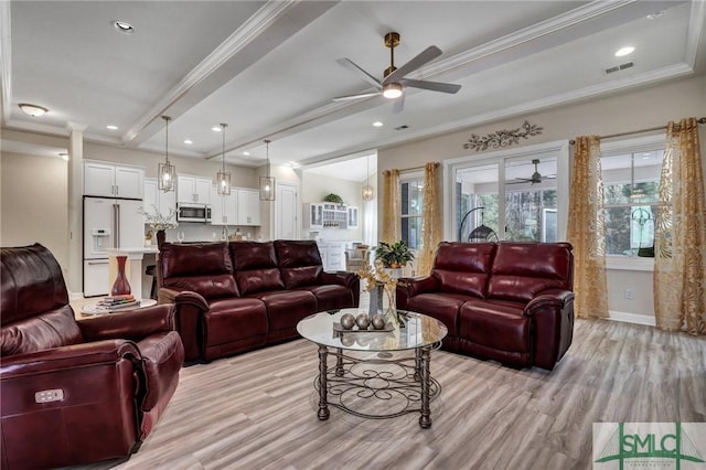 living area featuring light wood-style floors, beam ceiling, visible vents, and crown molding