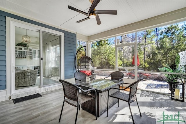 sunroom / solarium featuring ceiling fan