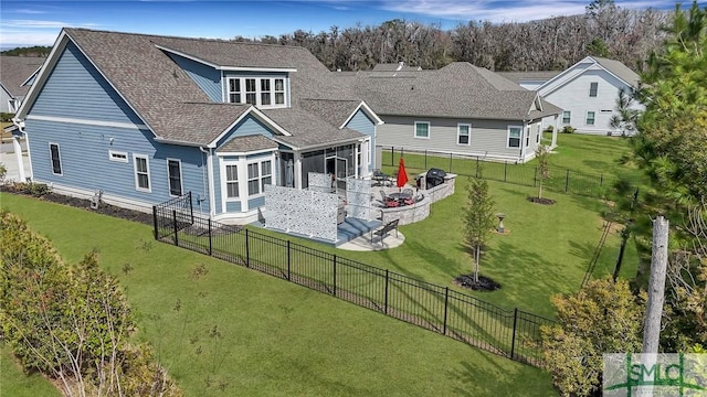 rear view of property with a sunroom, a fenced backyard, a lawn, and a patio