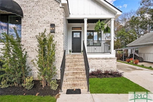 1212 Seiler Ave, Savannah, GA 31404 - doorway to property with board and batten siding and a porch