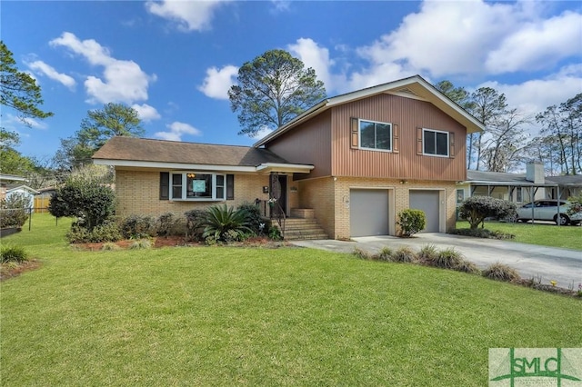 split level home with driveway, a front yard, a garage, and brick siding