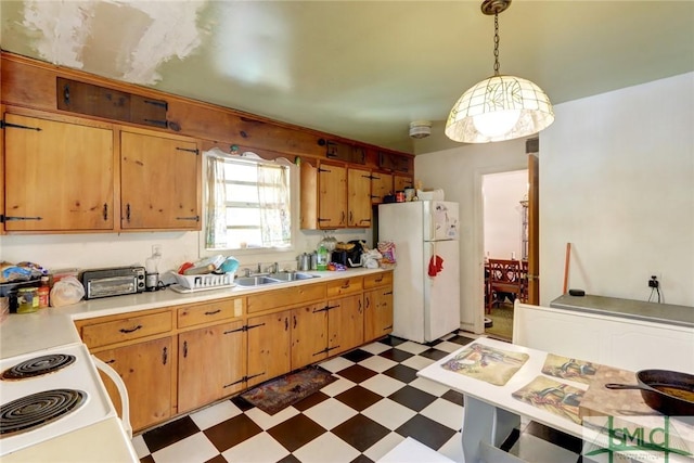 kitchen featuring white appliances, dark floors, light countertops, and decorative light fixtures