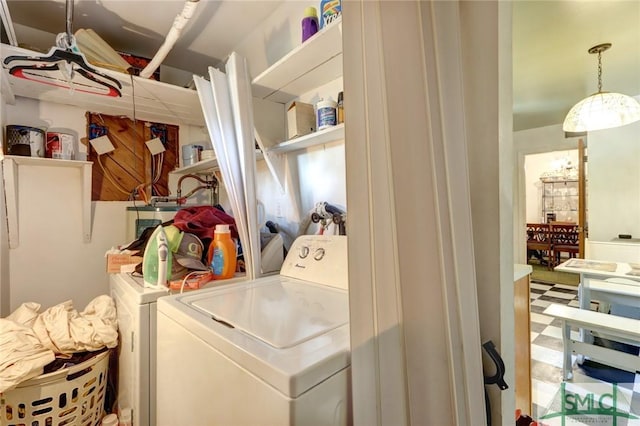 washroom featuring tile patterned floors, laundry area, and separate washer and dryer